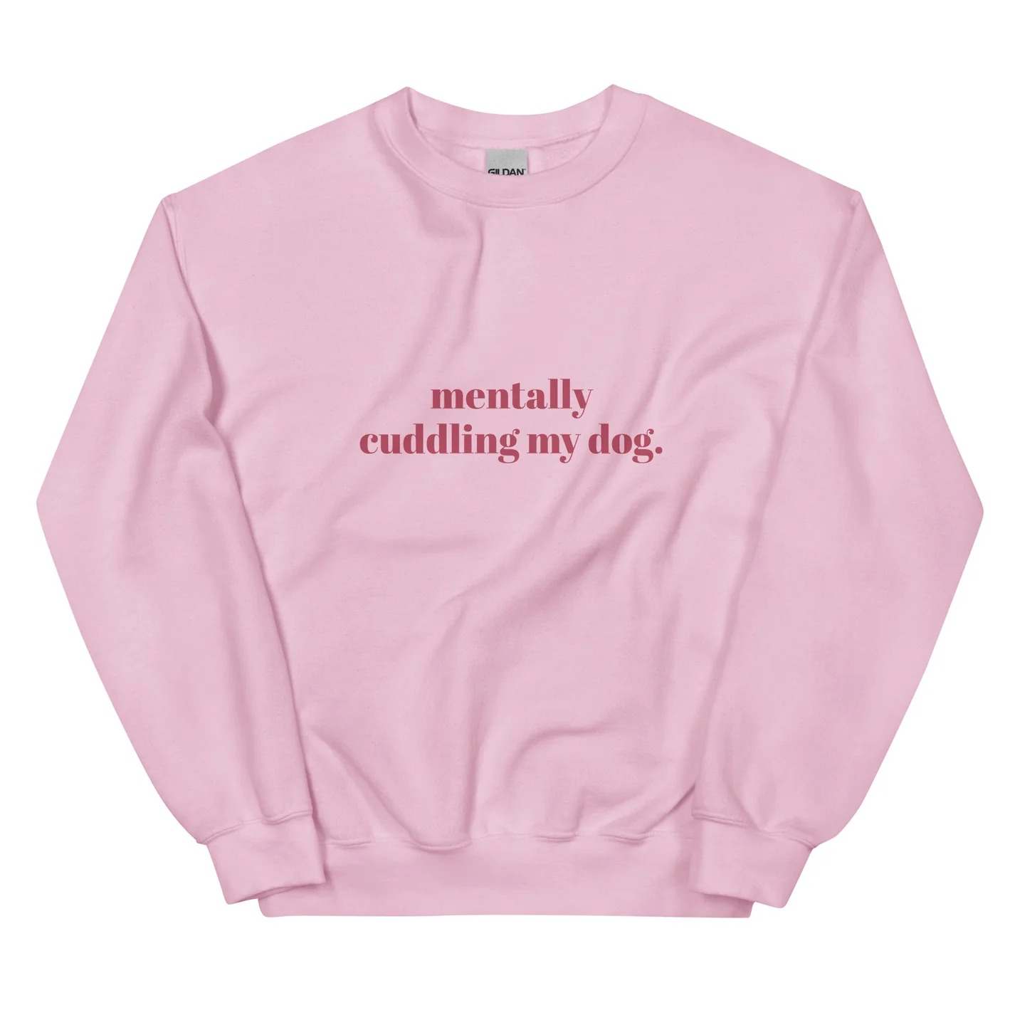 A light pink sweatshirt featuring the text "mentally cuddling my dog" in dark pink lettering on the front.