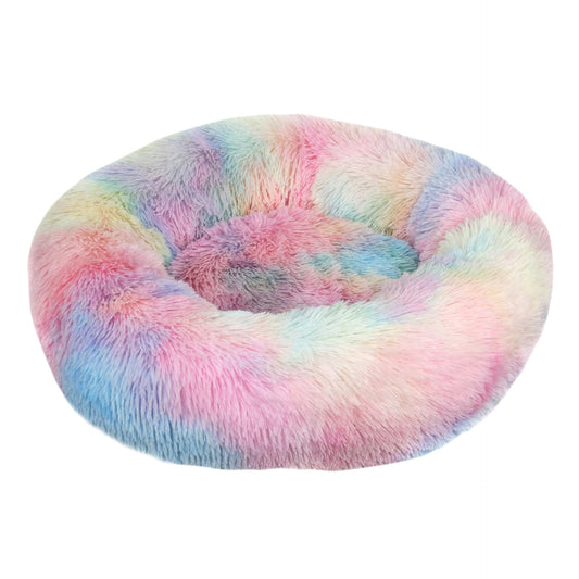 A rainbow plush dog bed shaped like a donut, offering a comfortable and secure space for small dogs to curl up and relax.