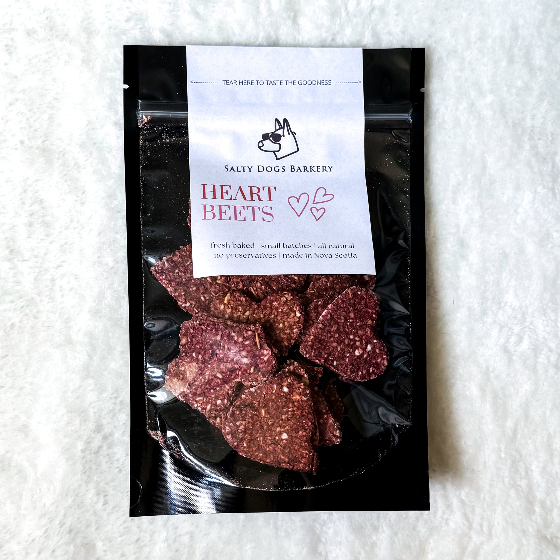 A bag of pink heart-shaped handmade dog treats.